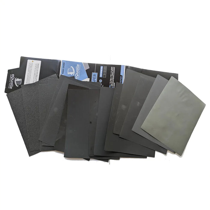 A fan of abrasive sheets beside open eQualle packaging.