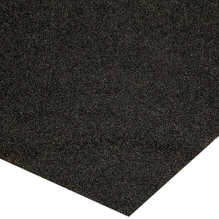 Close-up of the abrasive surface and corner of a dark sandpaper sheet.