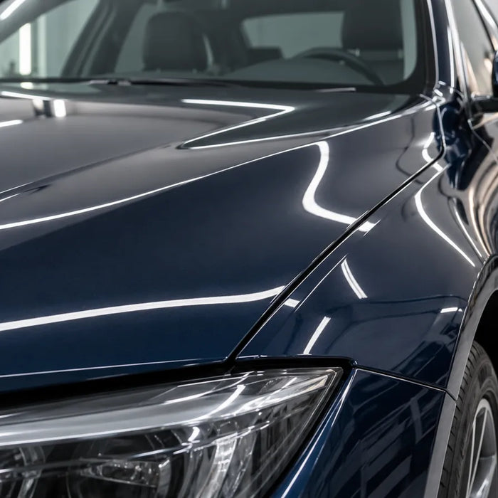 Illustration of dark vehicle paint reflecting workshop lights.