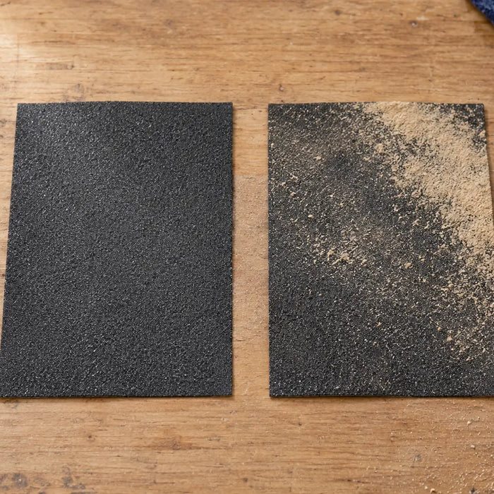 Illustration comparing clean abrasive with loose tan debris on abrasive; resin loading is not established.
